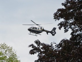 An OPP helicopter flies over the West Rocks just west of Owen Sound late Thursday morning.