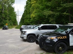 Police vehicles at the end of Concession 3 at the West Rocks Management Area on Friday.