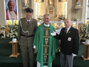Parish priest at St. Joseph's Church for 15 years, Fr. Adam Wróblewicz, centre, is flanked by Slawomir Dobrowolski, left, a board member of the local Polish Combatants Association and Adam Sikora, Canadian president of the Polish Combatants Association, as the priest was presented with the Gold Combatants' Cross on July 18.