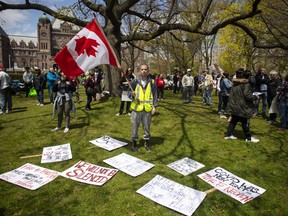 Researchers say conspiracy theories around COVID-19 are spreading at an alarming rate across the country — and they warn that misinformation shared online may lead to devastating consequences and push Canadians to shun important safety measures. Protesters gather outside the Ontario Legislature in Toronto, as they demonstrate against numerous issues relating to the COVID-19 pandemic on Saturday, May 16, 2020. THE CANADIAN PRESS/Chris Young
