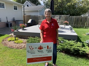 Sharon Montreuil, facilitator for the Timmins Parkinson Support Group, stands in her backyard Friday afternoon next to a sign detailing statistics about the disease. Montreuil said she got involved with creating a support group when her best friend's husband was diagnosed with Parkinson's. Elena De Luigi/The Daily Press