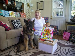 Natasha Baguley of London taught her German shepherd Kaiserin to paint pictures and is selling the works on Etsy to raise money for Tripawds, a support community for three-legged pets. (Derek Ruttan/The London Free Press)