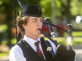Justyn Reid, 19, of London plays bagpipes in front of a L'Arche London home. (Mike Hensen/The London Free Press)