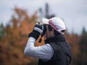 A Nature Conservancy of Canada volunteer bird watching at an event. NCC photo