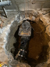 Backwater valve is shown inside a basement.