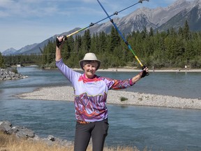 Mandy Johnson, Nordic walking instructor with Active by Nature, holds her Urban Poling poles up on the Bow River Trail in Canmore. photo by Pam Doyle/www.pamdoylephoto.com
