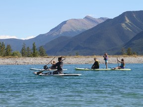 Parks Canada visitor safety reported a record busy summer responding to 11 river rescues, and two drownings in Banff, Yoho and Kootenay national parks due to higher visitation and a lack of water safety experience. (Pictured) Paddleboarders enjoy the sunshine, two people in the photo are not wearing life jackets. Parks visitor safety cautioned that having a PFD while on a watercraft is a legal requirement, especially on glacier fed water. Photo Marie Conboy.