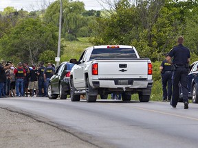 Ontario Provincial Police officers move toward a group of indigenous protesters talking with liaison officers on Sixth Line near Argyle Street South in Caledonia on Wednesday.