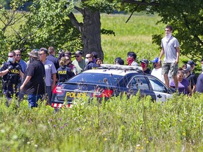 Rocks could be heard hitting police vehicles as Ontario Provincial Police officers are slowly pushed back by a large group of Indigenous protesters on Sixth Line near Argyle Street South in Caledonia over the noon hour on Wednesday. Earlier in the morning, a large contingent of police removed protesters occupying a nearby residential construction site, prompting supporters from the nearby Six Nations of the Grand River Territory to arrive.