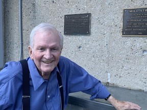 Former Brantford alderman Art Stanbridge in front of a plaque honoring his contributions to the revitalization of the city's downtown.