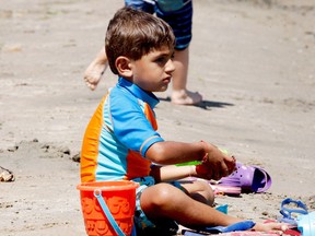 Avtej Dhaliwal, 3, of Ottawa, builds a sandcastle at the St. Lawrence Park beach on the Civic Holiday Monday. (FILE PHOTO)