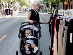 SPACE TO SHOP SATURDAY
Kristen Dixon, of Brockville, looks through clothes on a rack on King Street while her son Carter, 14 months, enjoys the experience a little less during Downtown Brockville's second Space to Shop Saturday event. (RONALD ZAJAC/The Recorder and Times)