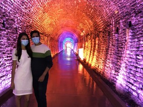 Nikesh Patel, of Brockville, takes his wife Jina on her first walk through the Brockville Railway Tunnel shortly after its reopening on Friday morning. (RONALD ZAJAC/The Recorder and Times)