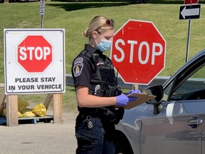 Brockville police Special Constable Bre Hamson gets information from a driver arriving at the city's COVID-19 assessment centre on Monday, Aug. 31, 2020. (FILE PHOTO)