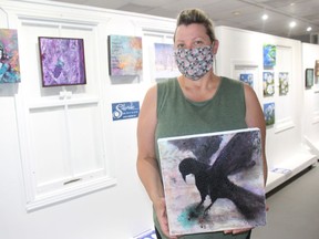 Cailuan Art Gallery & Store owner Tracy Lynn Davies, with her mixed-media piece Raven, at the Square Foot Show. Photo on Sunday, August 2, 2020, in Cornwall, Ont. Todd Hambleton/Cornwall Standard-Freeholder/Postmedia Network