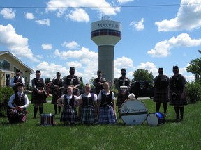 Some of the members of the Glengarry Pipe Band, and several Highland Dancers, posing for a photo near the water tower after a "Pipergram'' performance early on Saturday afternoon at a home on the Main Street in the village. Photo on Saturday, August 1, 2020, in Maxville, Ont. Todd Hambleton/Cornwall Standard-Freeholder/Postmedia Network