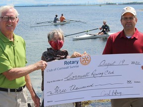 From left are Glen Grant (Cornwall Rowing Club committee member), and Carol Bennett Bray and Martin Nadon of the  Rotary Club of Cornwall Sunrise. Rowing club members in the water include president Kevin Donnelly, and (background) David Franks and Natasha Crocker. Photo on Wednesday, August 19, 2020, in Cornwall, Ont. Todd Hambleton/Cornwall Standard-Freeholder/Postmedia Network