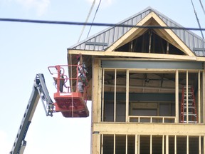 The cap for the West Perth Fire Hall's hose drying tower, which will also house the 1912 bell and clock from the former Mitchell post office, was lifted into place Aug. 18. Work is progressing nicely on the fire hall, but the unique architectural element of the clock and bell, saved when the post office was torn down in 1974, will make it stand out even more. ANDY BADER/MITCHELL ADVOCATE