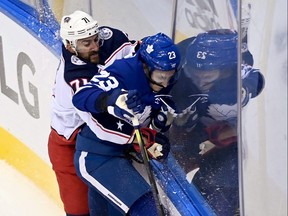 Leafs legend Wendel Clark says the team could use someone like Blue Jackets forward Nick Foligno, seen here crunching Travis Dermott in their recent play-in series. THE CANADIAN PRESS