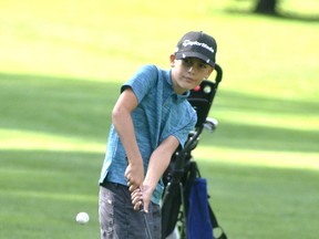 Max Hannon watches his chip onto the green during action from the Junior Club Championship at the Mitchell Golf & Country Club Aug. 25. ANDY BADER/MITCHELL ADVOCATE