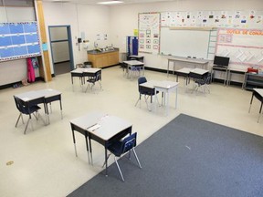 An empty classroom with intentionally-spaced desks awaits returning students. File photo