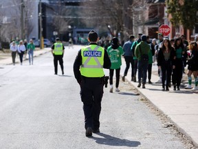 Kingston Police worked to keep Queen's University students on sidewalks and in yards as they gathered to party in the university district leading up to St. Patrick's Day in Kingston on Saturday, March 14, 2020. Meghan Balogh/The Whig-Standard/Postmedia Network