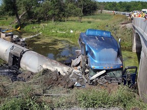 A transport truck in the ditch off the eastbound lanes of Highway 401 in Kingston on Thursday. (Steph Crosier/The Whig-Standard)