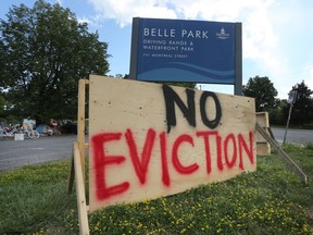A plywood sign at the entrance to Belle Park on Monday proclaims "No Eviction" on Monday. Campers who have lived in the parking lot to the park were given a July 31 deadline to find alternative housing, and activists are saying they will block any attempt at forced eviction for the camp's handful of remaining residents. (Meghan Balogh/The Whig-Standard)