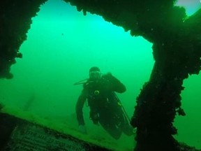 Diver Laurrie Liddle in 2019 outside the front of Effie Mae, a 12-metre wooden boat launched in 1968 and sunk in Lake Ontario in 1993. (Laurrie Liddle/Supplied Photo)