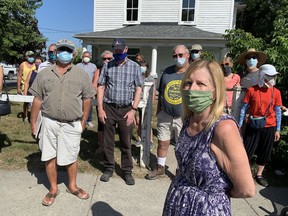 Kimberley Thomas, foreground, and other members of the Wolfe Island Historical Society, says they want alternatives to the planned demolition of a house in Marysville, Ont. on Wednesday, Aug. 26, 2020. 
Elliot Ferguson/The Whig-Standard/Postmedia Network