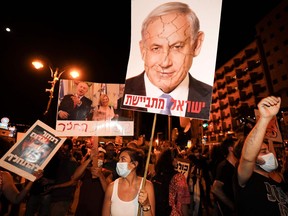 Protesters chant slogans during a demonstration of thousands against the Israeli government near the prime minister's residence in Jerusalem on Aug. 2. Thousands protested against Prime Minister Benjamin Netanyahu across Israel, demanding he resign over alleged corruption and a resurgence of coronavirus cases. (Menahem Kahana/Getty Images)