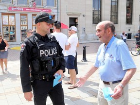 Kingston Police Const. Fil Wisniak chats with recovered stabbing victim Terry Stafford before Wisniak received the Police Association of Ontario 2020 Police Hero On-Duty Difference Maker Award in August 2020 for his response to a stabbing in presented an Ontario Medal for Police Bravery in downtown Kingston in September 2019. Last Friday, he presented an Ontario Medal for Police Bravery.