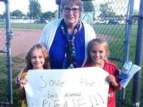 Young local athletes, the Watkins girls, came out to support Arlene Cartwright (centre). More than 600 people have come together through social media, petitions, and rallies to do what they can to save the Arlene Cartwright ball diamond for everyone to play on.  Supplied by Terry Watkins