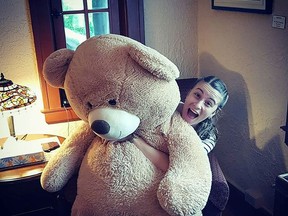 Evan Schonfeldt from the the Museum of Northern History gives a big hug to this Teddy Bear that recently “slept over” at the facility.