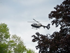 An OPP helicopter flies over the West Rocks Management Area on the edge of Owen Sound as part of a search for a missing man Thursday morning.