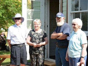 Doug Cox, Dorothy Bernard (Cox), Gary Roberts, and Kathleen Koethler pose infront of the A.E. Cox office replica during the exhibits ribbon cutting ceremony on Aug. 1.