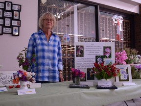Ianthe Goodfellow, co-organizer of the Sweet Pea Challenge, stands with submissions within the Ranchland Mall on Friday, July 31.
