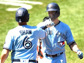 Randal Grichuk, right, of the Blue Jays celebrates a two-run homer with Travis Shaw, left, in the sixth inning during a game against the Orioles at Oriole Park at Camden Yards in Baltimore, Wednesday, Aug. 19, 2020.