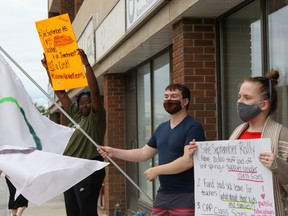 L-R: Kg Banjoko, Christopher Whelan and Una Rhoddy protest Alberta's plans for school reopenings outside the office of Tany Yao, UCP MLA for Fort McMurray-Wood Buffalo, on Friday, Aug. 21, 2020. Sarah Williscraft/Fort McMurray Today/Postmedia Network