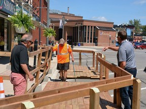 Stratford economic response and recovery task force member John Kastner leads a team of volunteers in assembling the 20th and final sidewalk-patio extension boardwalk in front of AO Pasta on Wellington Street in downtown Stratford last summer. (Galen Simmons/Beacon Herald file photo)