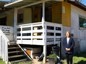 Shirley Jensen-Klassen stands outside of the home in Cheecham Village on Wednesday, Aug. 26, 2020, where she has been living without essential services.