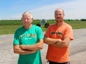Roger and Caleb Thurston with Korny Korners stand beside Blackwell Side Road where it passes by their family farm. They're calling for better stop signs and a speed limit reduction to improve safety. Sarnia city council in July commissioned a staff report. (Terry Bridge/The Observer)