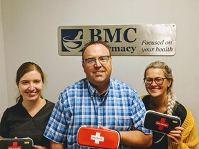 BMC Pharmacy assistant Megan VanGurp, pharmacist and manager Marcel Laporte, and pharmacy assistant McKenna Gladwish pose with naloxone kits in this file photo from 2019. The pharmacy is hosting an event Aug. 31 for International Overdose Awareness Day.