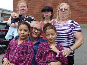 A surprise retirement celebration was held on Sunday for Vernon Morrow at Simcoe Composite School. Morrow has worked as a custodian for more than 42 years, first with the Norfolk Board of Education and then the Grand Erie District School Board. With Morrow is his wife Carol, daughters Christine and Carol Anne and grandchildren, Kyleigh, 8, Kiara, 7, and eight-week-old Kymani. MICHELLE RUBY PHOTO