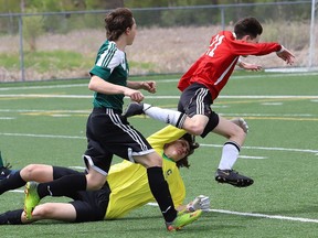In this file photo, Mike Bona, right, of St. Charles Cardinals, is upended by goaltender Harrison Wilson, of Confederation Chargers, during action at the junior boys high school soccer final at James Jerome Sports Complex in Sudbury, Ont. Soccer fields in the city have been quiet this summer because of the pandemic, but the Greater Sudbury Soccer Club will play a stylized return-to-train soccer format starting as early as Aug. 31.