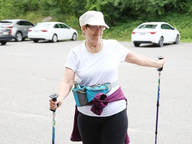 Urban poler Cecile Richardson cools down while social distancing after a hike in Sudbury, Ont. on Tuesday August 4, 2020. A group of urban polers are taking part in the Sudbury Camino, a self-guided series of hiking adventures during the month of August. John Lappa/Sudbury Star/Postmedia Network