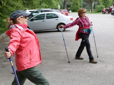 Urban polers Janie Wright, left, and Muffie McIntosh cool down while social distancing after a hike in Sudbury, Ont. on Tuesday August 4, 2020. A group of urban polers are taking part in the Sudbury Camino, a self-guided series of hiking adventures during the month of August. John Lappa/Sudbury Star/Postmedia Network