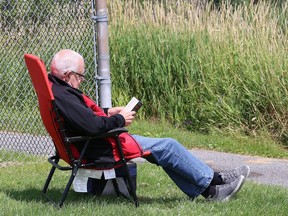 A man relaxes in solitude while reading a book at James Jerome Sports Complex in Sudbury, Ont. on Wednesday August 5, 2020.