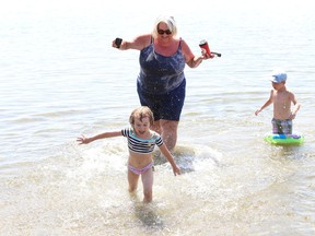 Eileen Doyle splashes her grandchildren, Kataleya and Jackson Chartrand at Whitewater Lake Park in Azilda, Ont. on Friday August 7, 2020. Sudbury is under a heat warning.
