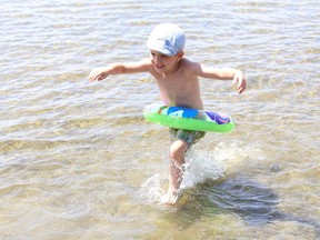 Jackson Chartrand, 4, splashes through the water at Whitewater Lake Park in Azilda, Ont. on Friday August 7, 2020.